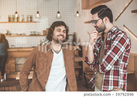 Joyful male students speaking in cafeteria 39792896
