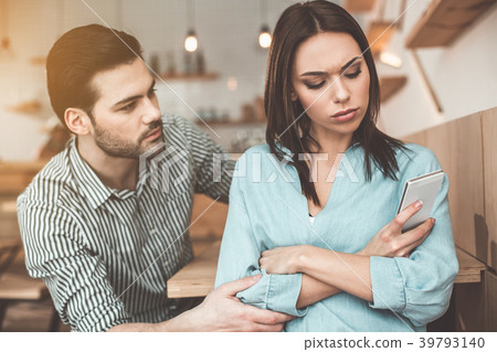 Guilty young man asking forgiveness in woman Guilty young man asking forgiveness in woman 39793140