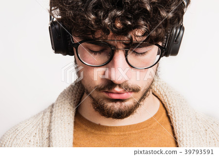 Portrait of a young man with headphones in a Portrait of a young man with headphones in a 39793591