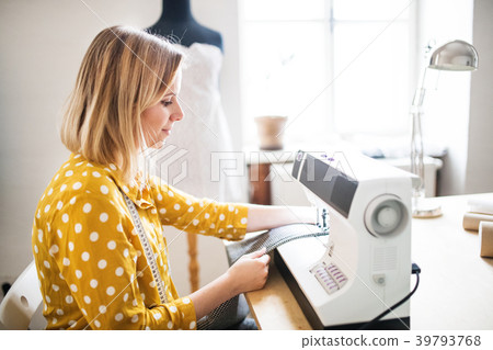 Young woman using sewing machine, startup business Young woman using sewing machine, startup business 39793768