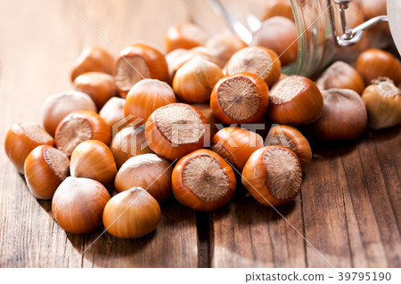 hazelnuts on wooden table 39795190
