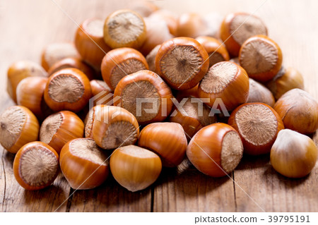 hazelnuts on a wooden table 39795191