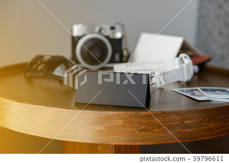Black plastic triangular sign standing on a table 39796611