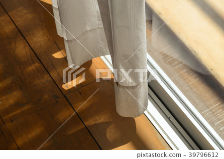 Sheer curtains with sunlight and wooden floor Sheer curtains with sunlight and wooden floor 39796612