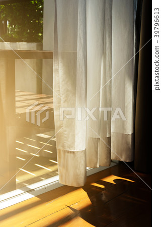 Sheer curtains with sunlight and wooden floor Sheer curtains with sunlight and wooden floor 39796613
