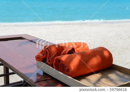 orange towels in wooden box near beach orange towels in wooden box near beach 39796616