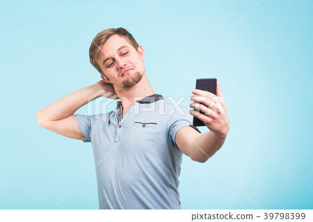 Funny man photographing himself on a smartphone 39798399