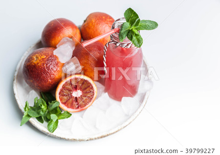 Blood oranges on a plate and juice in a glass 39799227