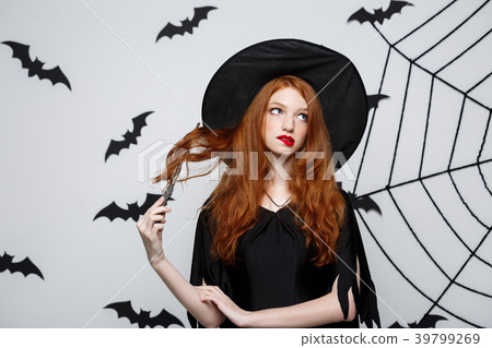 Halloween Concept - Beautiful Witch playing with Halloween Concept - Beautiful Witch playing with 39799269
