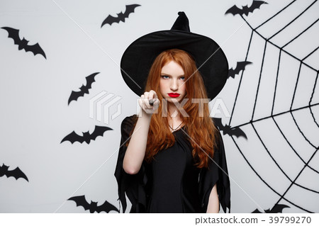 Halloween Concept - Beautiful Witch playing with Halloween Concept - Beautiful Witch playing with 39799270