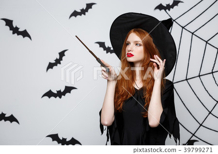Halloween Concept - Beautiful Witch playing with Halloween Concept - Beautiful Witch playing with 39799271