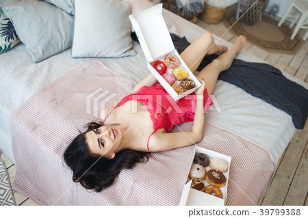 Beautiful slim sexy girl is lying in bed with 39799388