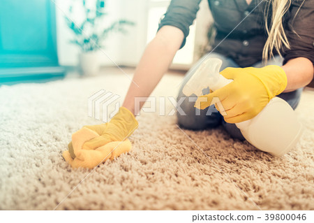 Housewife cleaning carpet. 39800046
