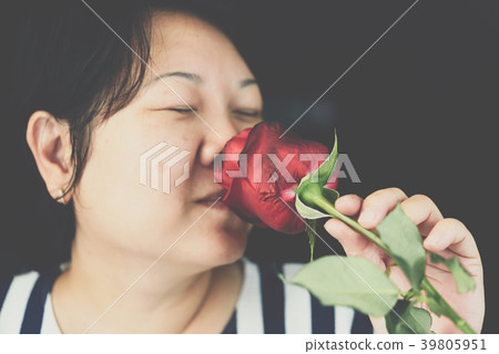 Woman smelling Red rose flower in Valentine's Day Woman smelling Red rose flower in Valentine's Day 39805951