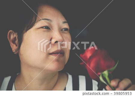 Woman smelling Red rose flower in Valentine's Day Woman smelling Red rose flower in Valentine's Day 39805953