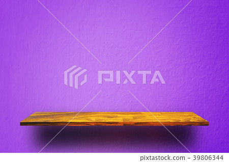 Empty wooden shelf on purple cement wall 39806344