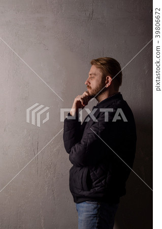 Pensive middle-aged bearded man in a black jacket 39806672