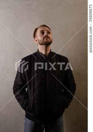 attractive bearded man in a black jacket and jeans 39806675
