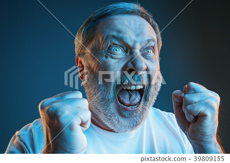 The senior emotional angry man screaming on blue 39809155