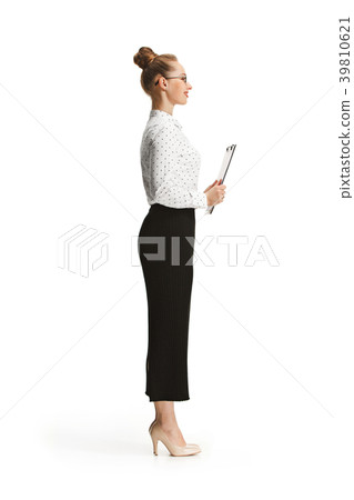 Full length portrait of a female teacher holding a Full length portrait of a female teacher holding a 39810621