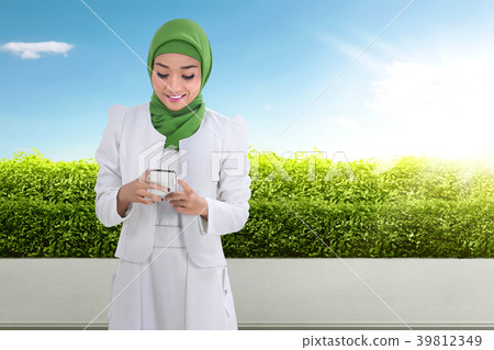 Pretty asian muslim woman using cellphone 39812349
