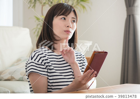 Young Japanese woman watching a smartphone indoors 39813478