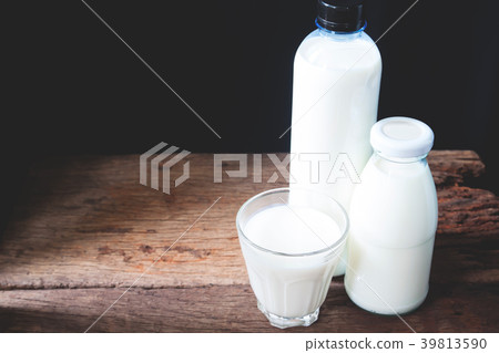 Fresh milk in drinking glass and two bottles Fresh milk in drinking glass and two bottles 39813590