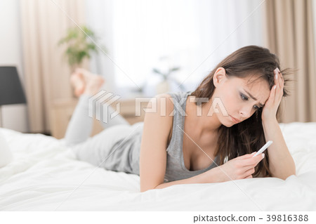 Young beautiful woman holding a pregnancy test. 39816388