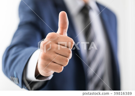 Business man shows thumb up sign gesture. 39816389