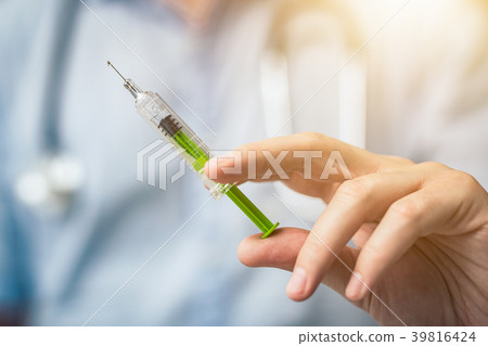 Syringe, medical injection in hand. Syringe, medical injection in hand. 39816424