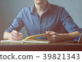 Businessman writing a document on notebook 39821343