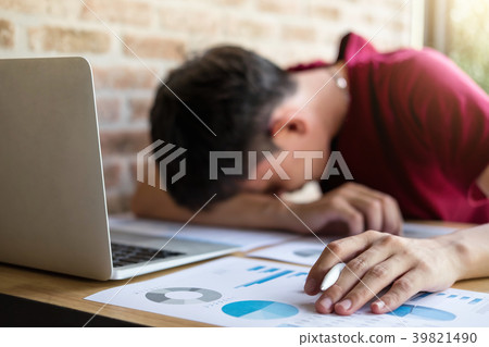 Tired businessman sleeping at work in modern office with hand ho Tired businessman sleeping at work in modern office with hand ho 39821490
