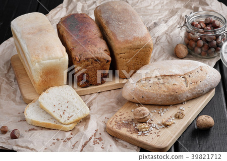 Different types of bread from the bakery, lie on a Different types of bread from the bakery, lie on a 39821712