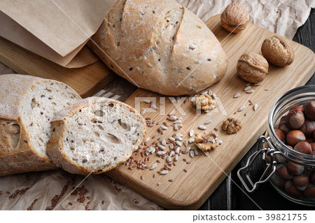 Loaves of gray bread with seeds, in a paper bag Loaves of gray bread with seeds, in a paper bag 39821755