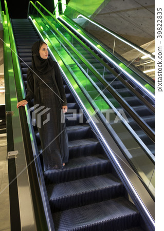 Muslim woman wearing in a hijab descends the Muslim woman wearing in a hijab descends the 39822835