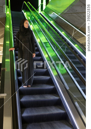 Muslim woman wearing in a hijab descends the Muslim woman wearing in a hijab descends the 39822836