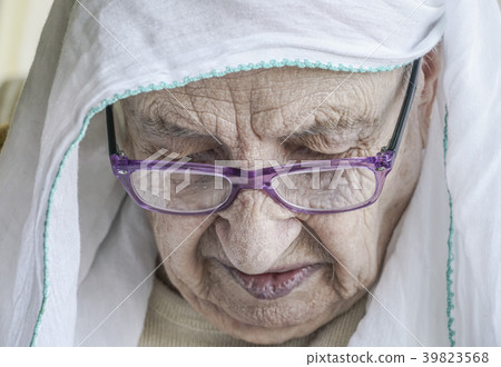 senior woman wearing headscarf while praying senior woman wearing headscarf while praying 39823568