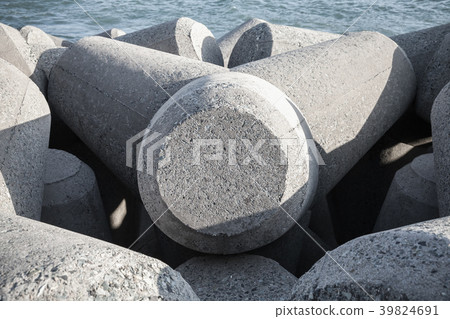 Gray concrete breakwater blocks close up Gray concrete breakwater blocks close up 39824691