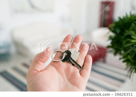 Mortgage concept. Men hand holding key with house 39826351