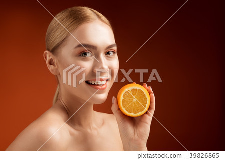 Healthy smiling woman with fruit rich in vitamin c 39826865