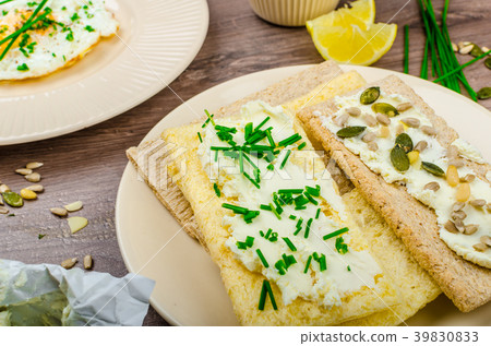 Crisp Crispbread with cheese spread with chives and Crisp Crispbread with curd cheese spread chives and seeds Crisp Crispbread with cheese spread with chives and Crisp Crispbread with curd cheese spread chives and seeds 39830833