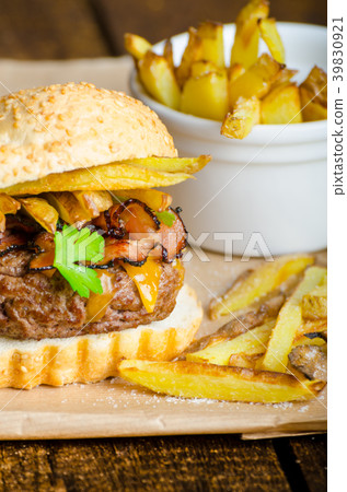 Beef burger with bacon, cheddar, homemade fries Beef burger with bacon, cheddar, homemade fries 39830921