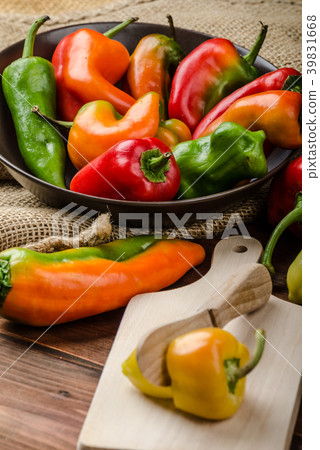 Slicing peppers with wood knife Slicing peppers with wood knife 39831668