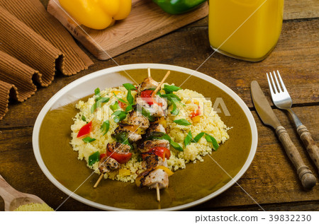 Couscous with vegetables and chicken skewer Couscous with vegetables and chicken skewer 39832230