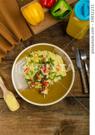 Couscous with vegetables and chicken skewer Couscous with vegetables and chicken skewer 39832233