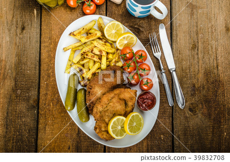 Big Chicken schnitzel with homemade chilli french fries 39832708