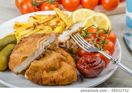 Big Chicken schnitzel with homemade chilli french fries Big Chicken schnitzel with homemade chilli french fries 39832732