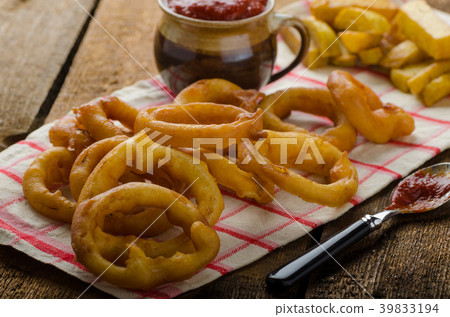 Onion rings, hot dip, french fries and Czech beer Onion rings, hot dip, french fries and Czech beer 39833194