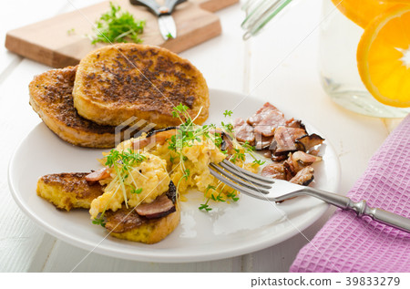 Scrambled eggs with French toast topped with watercress Scrambled eggs with watercress, french toast 39833279