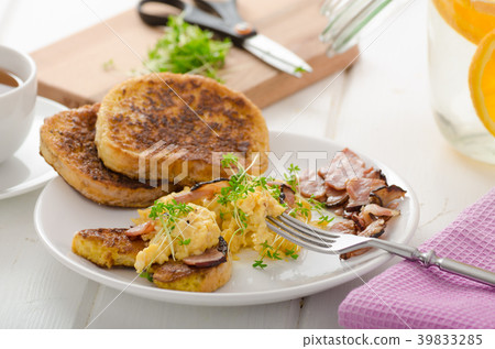 Scrambled eggs with French toast topped with watercress Scrambled eggs with watercress, french toast 39833285